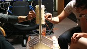 Hands on both sides of the a plexiglass rack to remove sticks.