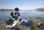 Student sampling water.