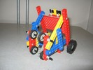 A triangular-framed robot, with wheels on two sides.