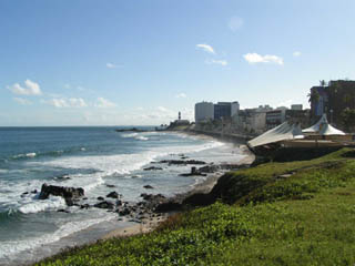 Photo of a beach with tall city buildings in the background.