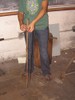 A curved piece of metal being measured with a yardstick.