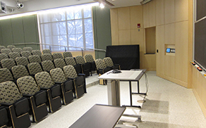 A small lecture hall with tiers of seats.