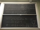 Energy related equations on two blackboards.