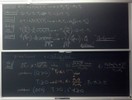 Nuclear reaction related equations on two blackboards.