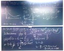 Ion-nuclear interaction related equations on two blackboards.