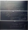 Neutron transport related equations and graphs on three blackboards.