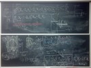 Neutron diffusion related equations and graphs on two blackboards.