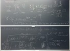 Neutronics related equations on two blackboards.