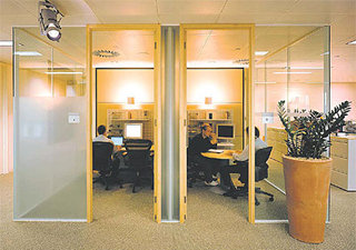 Employees working and holding meetings in modern office building.