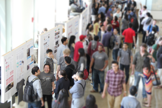 People speaking in front of a poster