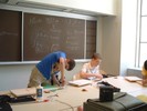 Two students working on their guitars.