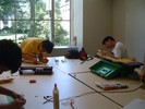 Two students working on their guitars.