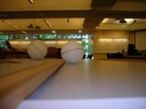 Two styrofoam balls on a table are photographed at eye level making them appear much larger than their actual size.