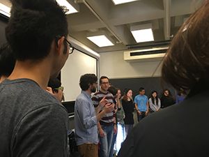 Close up image of students standing in a circle.