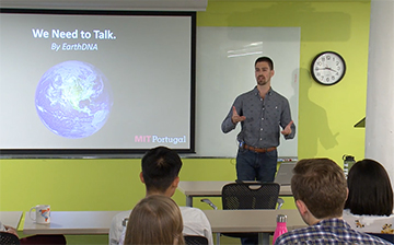 Man standing in front of a power point presentation.